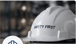 White safety hard hat on an industrial site representing occupational health and safety